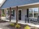 Inviting covered front porch featuring rocking chairs and swing, enhancing the home's curb appeal at 5 Morning Dove Ct, Clayton, NC 27520