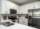 Modern kitchen with white cabinets, stainless steel appliances, and granite countertops at 5 Morning Dove Ct, Clayton, NC 27520