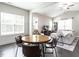 Cozy living and dining area with dark wood floors, neutral colors, and lots of natural light at 5 Morning Dove Ct, Clayton, NC 27520
