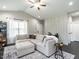 Bright living room with a large sectional couch, stylish rug, and lots of storage space at 5 Morning Dove Ct, Clayton, NC 27520