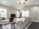 Bright and airy living room with large windows and neutral-toned furnishings at 5 Morning Dove Ct, Clayton, NC 27520