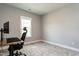 Neutral office featuring wood desk and chair, with carpet flooring and a window for natural light at 5 Morning Dove Ct, Clayton, NC 27520