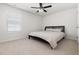 Bedroom with neutral carpet, a ceiling fan, and a black bed frame at 5112 Lizard Tail Ln, Raleigh, NC 27603