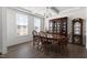 Formal dining room with wooden table, chairs, hutch, and modern lighting at 5112 Lizard Tail Ln, Raleigh, NC 27603