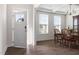 Bright dining area with an open door, a chandelier, and a wooden dining table and chairs at 5112 Lizard Tail Ln, Raleigh, NC 27603