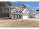 Charming two-story home with a two-car garage and a combination brick and stone facade at 5112 Lizard Tail Ln, Raleigh, NC 27603