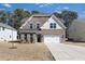 Attractive home featuring a two-car garage, brick accents and a well-maintained lawn at 5112 Lizard Tail Ln, Raleigh, NC 27603