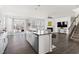 Open-concept kitchen island with stainless steel appliances, and a cozy living area at 5112 Lizard Tail Ln, Raleigh, NC 27603
