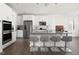 Modern kitchen with stainless steel appliances, quartz countertops, and a spacious island with seating at 5112 Lizard Tail Ln, Raleigh, NC 27603
