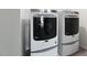 Laundry room with modern white front load washer and dryer at 5112 Lizard Tail Ln, Raleigh, NC 27603
