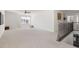 Upstairs loft area with neutral carpet, window and hammock chair, open to downstairs living space at 5112 Lizard Tail Ln, Raleigh, NC 27603