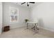 Bright home office features a modern desk, chair, large window and neutral carpeting at 5112 Lizard Tail Ln, Raleigh, NC 27603
