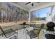 Covered patio with outdoor seating and a view of the wooded backyard at 5112 Lizard Tail Ln, Raleigh, NC 27603