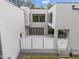 Aerial view of a home featuring a stylish modern courtyard with sleek concrete patio, privacy fence and gated steps at 5217 Tanglewild Dr, Raleigh, NC 27613