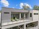 Relaxing balcony with lounge seating, a small dining set, stainless steel railings, and outdoor kitchen below at 5217 Tanglewild Dr, Raleigh, NC 27613