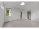 Bedroom featuring light grey wood flooring, recessed lighting, and a view from a single window at 5217 Tanglewild Dr, Raleigh, NC 27613