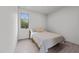 Cozy bedroom featuring natural light and a comfortable bed with neutral bedding at 5217 Tanglewild Dr, Raleigh, NC 27613