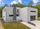 Contemporary home design featuring a stylish entrance, modern gray cladding, and a well-maintained lawn at 5217 Tanglewild Dr, Raleigh, NC 27613