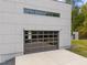 Close-up of a glass-paneled garage door highlighting the modern aesthetic of the home's exterior at 5217 Tanglewild Dr, Raleigh, NC 27613