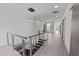 Spacious hallway with modern lighting, stainless steel railing, and clear sight lines to all areas at 5217 Tanglewild Dr, Raleigh, NC 27613