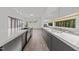 Bright kitchen boasts stainless steel appliances, sleek cabinets, and ample counter space with large windows at 5217 Tanglewild Dr, Raleigh, NC 27613