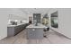 Modern kitchen featuring gray cabinetry, quartz countertops, and a central island with bar seating at 5217 Tanglewild Dr, Raleigh, NC 27613