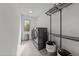 Well-lit laundry room with modern washer and dryer, shelving, and storage baskets at 5217 Tanglewild Dr, Raleigh, NC 27613