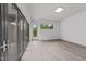 Bright living space with wide, folding glass doors and modern hardwood floors, capturing lots of natural light at 5217 Tanglewild Dr, Raleigh, NC 27613