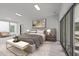 Comfortable main bedroom with hardwood floors, balcony access, a bench, and an area rug at 5217 Tanglewild Dr, Raleigh, NC 27613