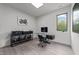 Bright office space with a modern desk, sleek shelving, natural light, and unique decor at 5217 Tanglewild Dr, Raleigh, NC 27613