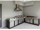 Outdoor kitchen featuring a grill, cooktop, and stainless steel cabinetry at 5217 Tanglewild Dr, Raleigh, NC 27613