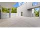 Modern home featuring a spacious concrete patio with a partial covering and a stylish white privacy fence at 5217 Tanglewild Dr, Raleigh, NC 27613