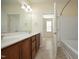 Bathroom featuring double vanity, large mirror, and shower-tub combination at 528 Weather Ridge Ln, Cary, NC 27513