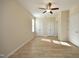Bright bedroom with neutral walls, wood-look flooring, and ample closet space at 528 Weather Ridge Ln, Cary, NC 27513
