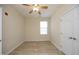A bright bedroom with light-colored walls and flooring and a window for natural light at 528 Weather Ridge Ln, Cary, NC 27513