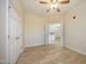Bright bedroom featuring a ceiling fan and light-colored walls and flooring at 528 Weather Ridge Ln, Cary, NC 27513