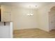 Open dining area with modern chandelier, neutral walls, and stylish flooring at 528 Weather Ridge Ln, Cary, NC 27513