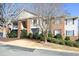 Inviting multi-Gathering home with brick and beige siding, balconies and lush landscaping at 528 Weather Ridge Ln, Cary, NC 27513