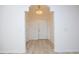 Bright foyer featuring a chandelier and attractive flooring, leading to a white door at 528 Weather Ridge Ln, Cary, NC 27513