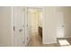 Hallway view leading to a bathroom with modern flooring, neutral walls, and white trim at 528 Weather Ridge Ln, Cary, NC 27513