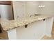 Breakfast bar area featuring granite countertop and decorative wood supports, great for entertaining at 528 Weather Ridge Ln, Cary, NC 27513