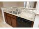 Functional kitchen featuring granite countertop, stainless steel sink, and black dishwasher at 528 Weather Ridge Ln, Cary, NC 27513