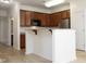 Modern kitchen with breakfast bar, stainless steel appliances, and ample cabinet space at 528 Weather Ridge Ln, Cary, NC 27513