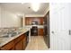 Modern kitchen featuring granite countertops, stainless steel appliances, and wood cabinets at 528 Weather Ridge Ln, Cary, NC 27513