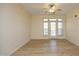 Bright living room with neutral walls and flooring, featuring a ceiling fan and balcony doors at 528 Weather Ridge Ln, Cary, NC 27513