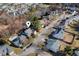 Aerial view of a house in a residential neighborhood with a pond at 5401 Green Feather Ln, Raleigh, NC 27604