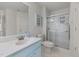 A blue painted vanity complements the shower with sliding glass doors in this bathroom at 5401 Green Feather Ln, Raleigh, NC 27604