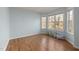 Bedroom with hardwood floors and window view with decorative pillows at 5401 Green Feather Ln, Raleigh, NC 27604
