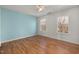 Spacious bedroom with wood-look floors and two bright windows at 5401 Green Feather Ln, Raleigh, NC 27604