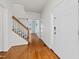 Entryway featuring hardwood floors, a staircase, and a view into adjacent rooms at 5401 Green Feather Ln, Raleigh, NC 27604